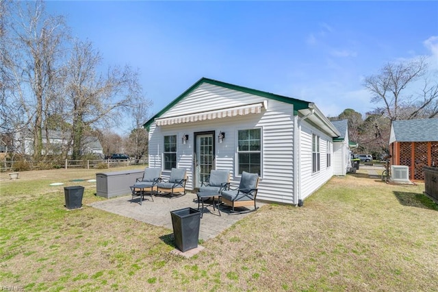 back of house featuring a patio, a lawn, and fence