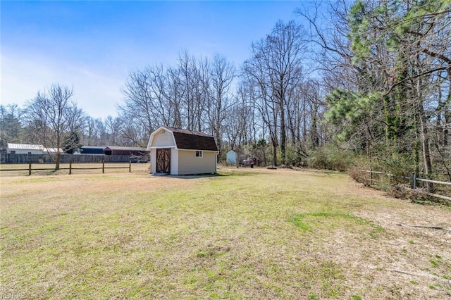 view of yard with a storage shed, an outdoor structure, and fence