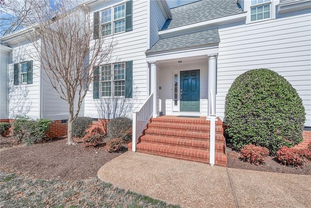 entrance to property with crawl space and a shingled roof