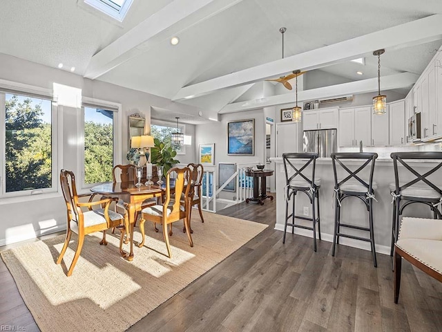 dining space featuring recessed lighting, lofted ceiling with skylight, and dark wood finished floors