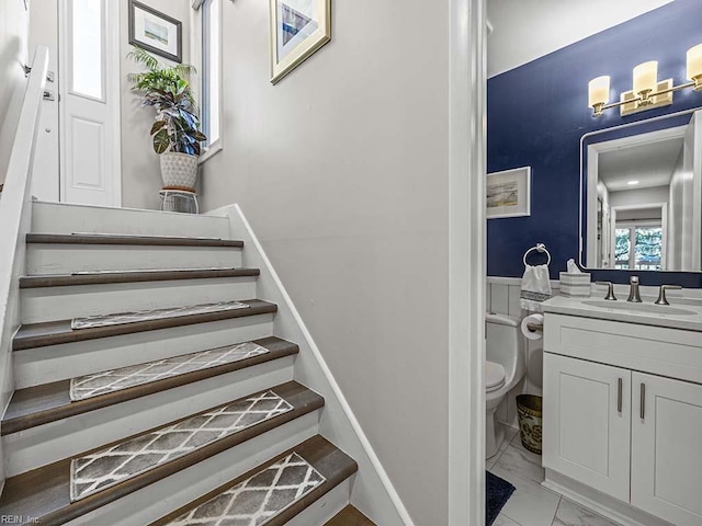 stairway featuring marble finish floor