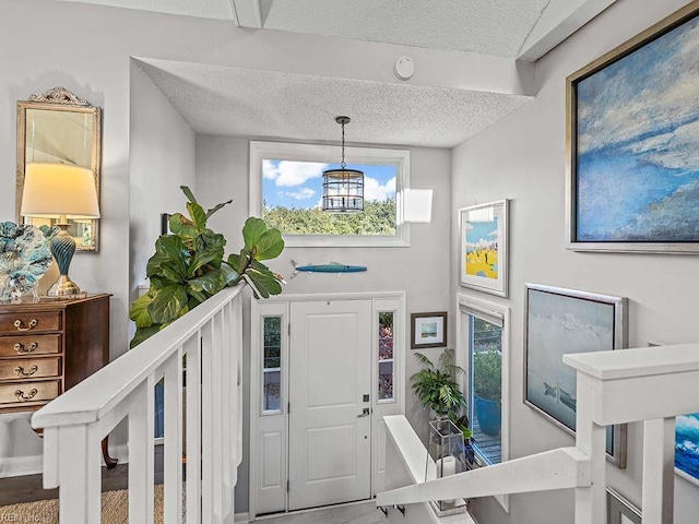 foyer with a textured ceiling