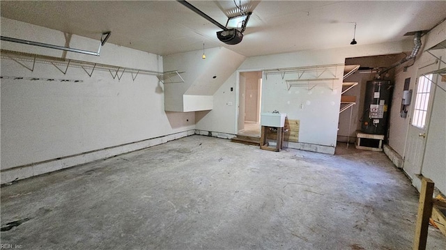 garage with a garage door opener, water heater, and a sink