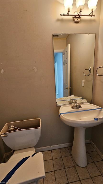 bathroom with tile patterned flooring and baseboards