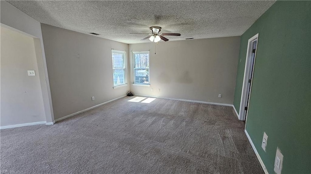 spare room featuring visible vents, baseboards, ceiling fan, and carpet floors