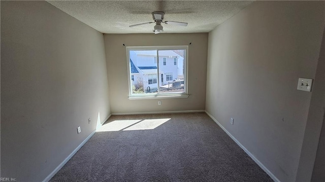 spare room featuring carpet flooring, a textured ceiling, baseboards, and a ceiling fan