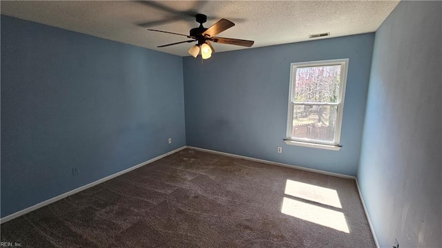 carpeted spare room featuring ceiling fan, baseboards, visible vents, and a textured ceiling