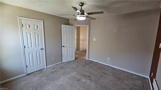 unfurnished bedroom with ceiling fan, baseboards, carpet floors, and a textured ceiling