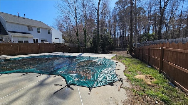 view of pool featuring a fenced in pool, a fenced backyard, and a diving board