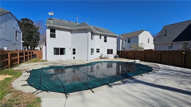 view of pool with a diving board, a fenced in pool, a fenced backyard, and a patio area