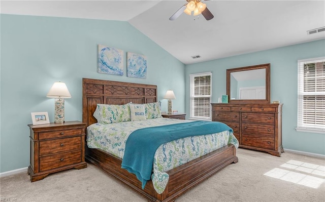 carpeted bedroom with lofted ceiling, baseboards, and visible vents