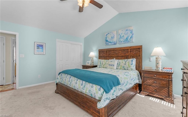 carpeted bedroom with lofted ceiling, a ceiling fan, a closet, and baseboards