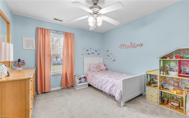 carpeted bedroom with visible vents and a ceiling fan