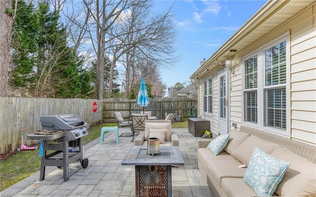 view of patio / terrace with outdoor lounge area, a fenced backyard, and grilling area