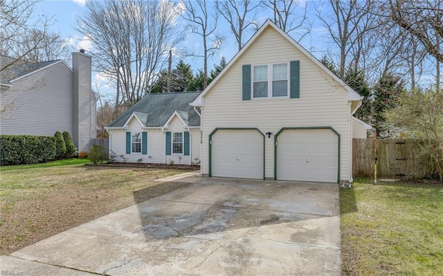 traditional home featuring a garage, a front yard, driveway, and fence