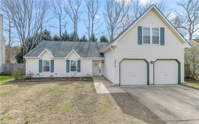 traditional home with a shingled roof, fence, concrete driveway, a front yard, and an attached garage