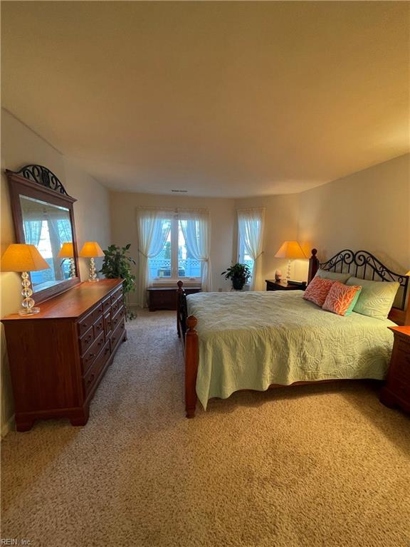 bedroom featuring light colored carpet