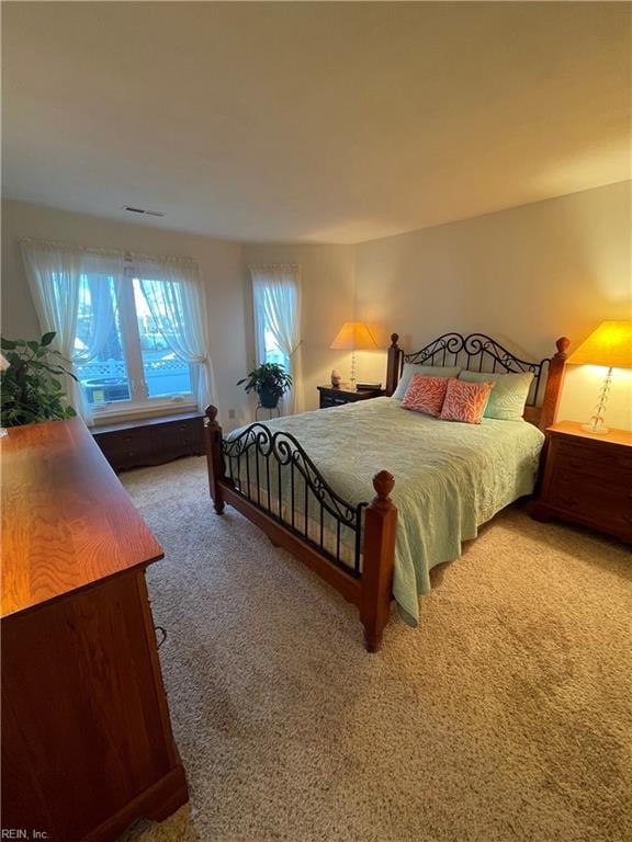 carpeted bedroom with visible vents