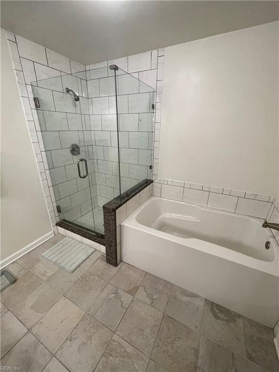 full bathroom with a stall shower and a bath