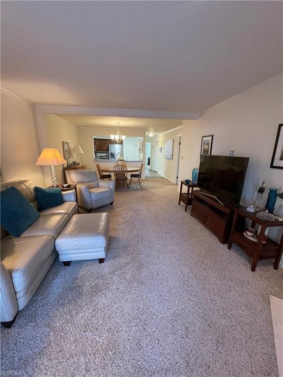 living room featuring light carpet, a chandelier, and crown molding