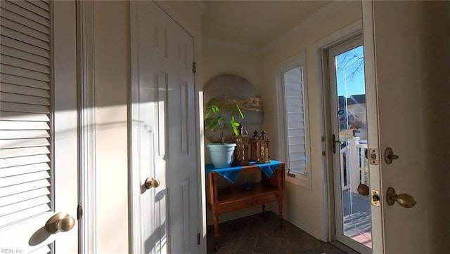 entryway with dark wood-style floors and ornamental molding