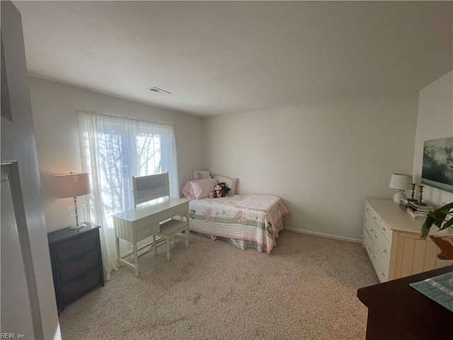 bedroom featuring visible vents, light colored carpet, and baseboards