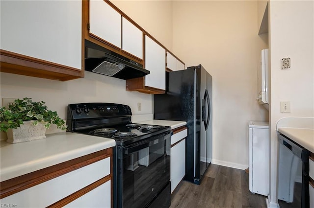 kitchen featuring black appliances, under cabinet range hood, light countertops, white cabinetry, and dark wood-style flooring