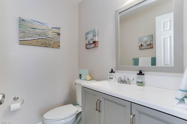 bathroom featuring toilet and vanity