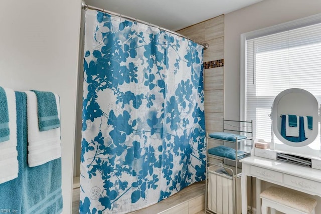 bathroom featuring a shower with shower curtain and wood finished floors