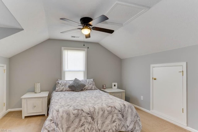 bedroom featuring visible vents, baseboards, ceiling fan, vaulted ceiling, and light colored carpet