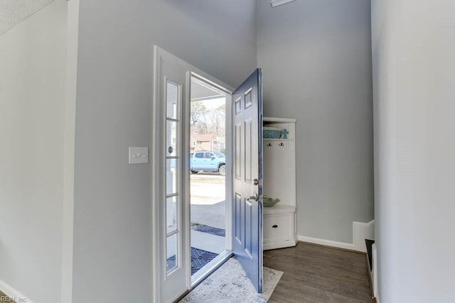 foyer with wood finished floors and baseboards