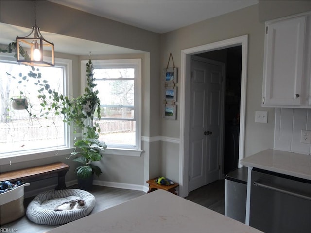 interior space featuring baseboards and wood finished floors