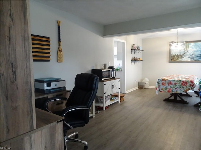 office area featuring baseboards and wood finished floors