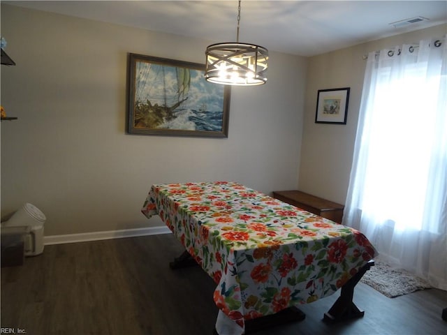 bedroom featuring visible vents, multiple windows, and wood finished floors