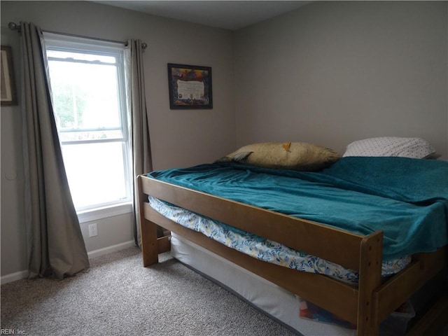 carpeted bedroom featuring baseboards