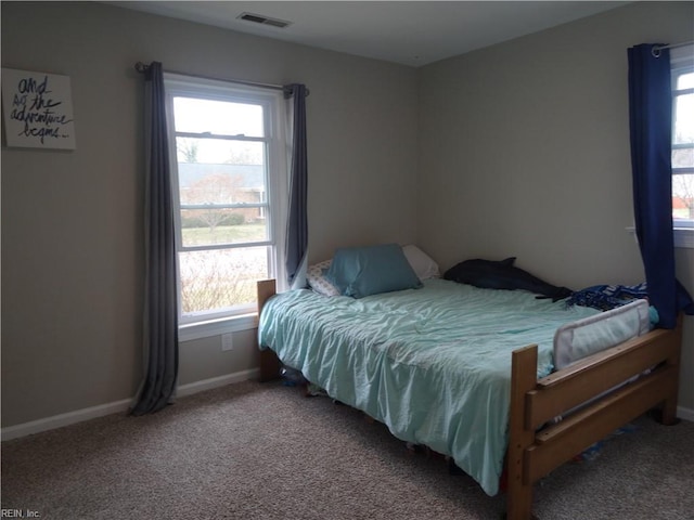 bedroom featuring visible vents, carpet flooring, baseboards, and multiple windows