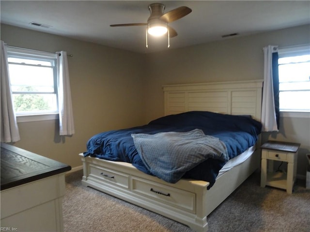 bedroom featuring visible vents, baseboards, carpet, and a ceiling fan