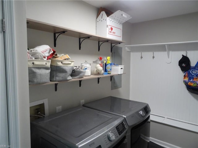 clothes washing area featuring laundry area and washer and clothes dryer