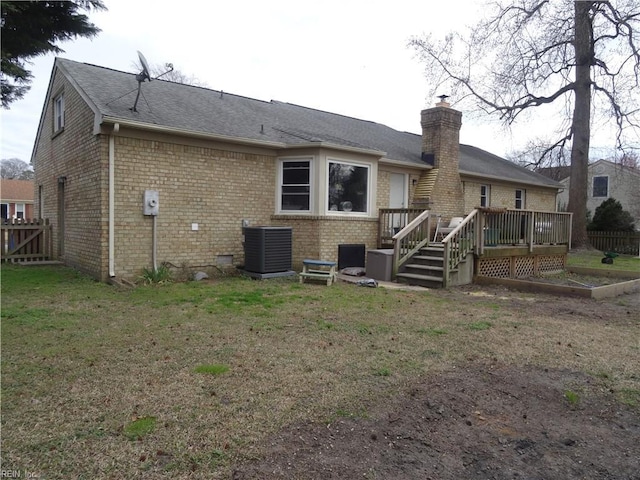 back of house with central air condition unit, a wooden deck, a chimney, and fence