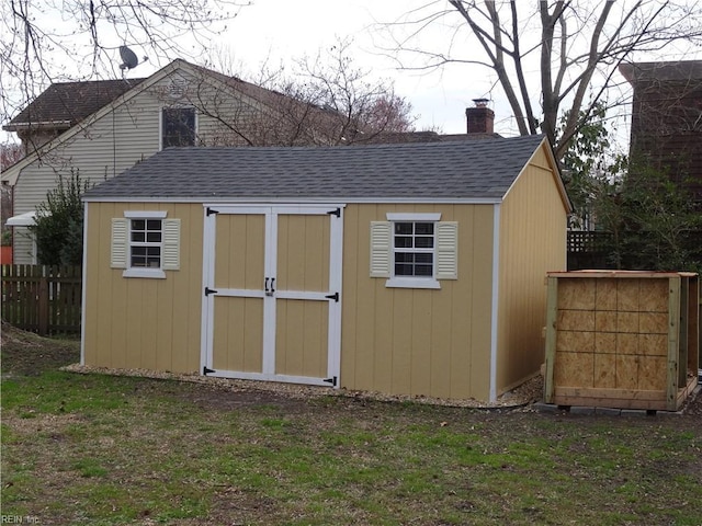 view of shed with fence