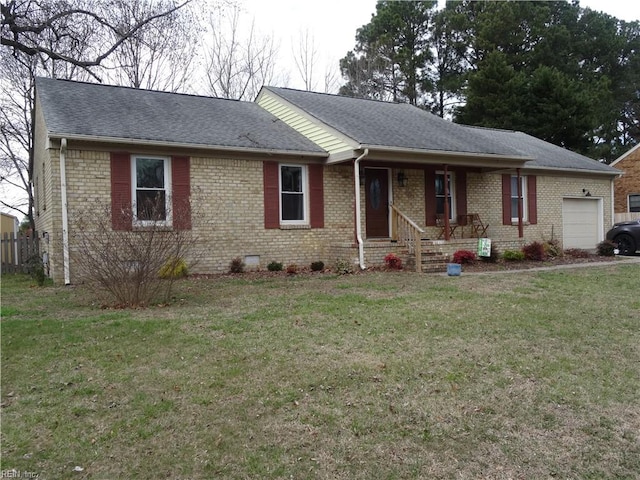 ranch-style home featuring crawl space, brick siding, an attached garage, and a front lawn