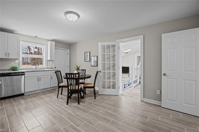 dining space with baseboards and wood tiled floor