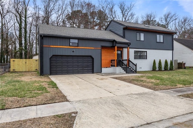 view of front facade with a gate, fence, concrete driveway, a front lawn, and a garage