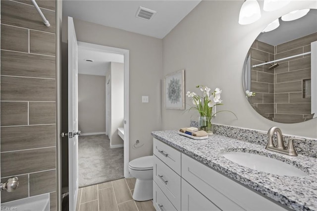 full bath with visible vents, walk in shower, wood finish floors, toilet, and vanity