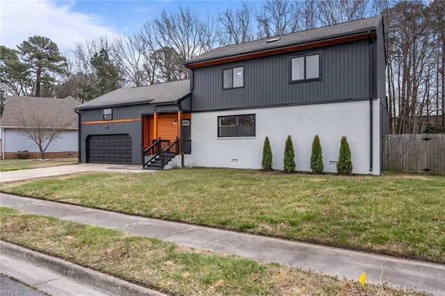 view of front of house featuring driveway, fence, a front yard, a garage, and brick siding