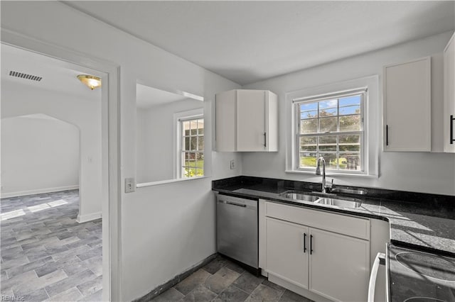 kitchen featuring baseboards, visible vents, a sink, white cabinets, and stainless steel dishwasher