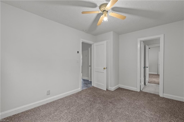 unfurnished bedroom with baseboards, ceiling fan, a textured ceiling, and carpet