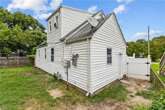 view of property exterior featuring a lawn and a fenced backyard