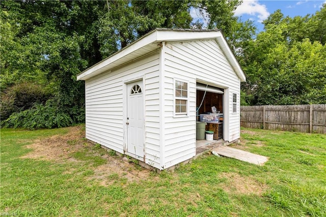 view of shed featuring fence