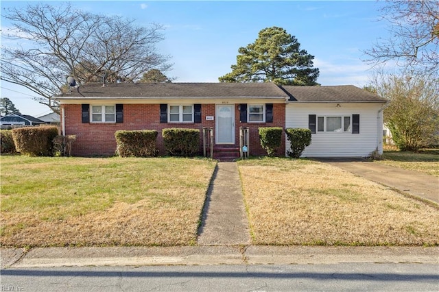 ranch-style home with brick siding and a front yard